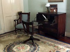12A The writing room has a beautiful rug and a wooden desk complete with inkwell, letter box and other writing paraphernalia Devon House mansion Kingston Jamaica